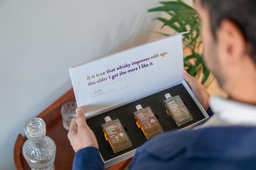 Image of a whisky loot unboxing experience with three miniature bottles